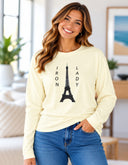 model wearing Women’s long sleeve Iron Lady butter tee featuring an Eiffel Tower photograph captured in Paris, France