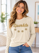 Woman wearing butter Sparkle long sleeve tee with gold chandelier-inspired lettering and decorative accents