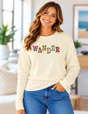 Woman wearing butter Wander long sleeve tee with colorful floral lettering created from Victoria Island flower photography