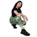 Person wearing a black t-shirt and green camouflage pants on a white background - Image on Me legendary Irish castle grounds leggings with pockets