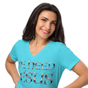 turquoise close up of model wearing Women’s We Need Jesus Sunrise V-neck tee with lettering filled with an Aruba sunrise photograph