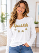 Woman wearing white Sparkle long sleeve tee with gold chandelier-inspired lettering and decorative accents