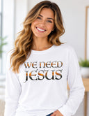 Woman wearing white We Need Jesus long sleeve tee featuring Mount Dora Florida sunset lettering