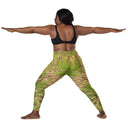 Women’s crossover leggings with pockets featuring foxtail fountain grass in green and pinkish-tan tones photographed in Yorba Linda, California