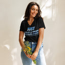 front black Women’s V-neck Just Breathe tee with lettering filled with a scenic Alaska water and mountain photograph