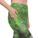 Right pocket view of model in crossover waist leggings with Legendary Irish Castle Secret Path print captured behind Blarney Castle, Ireland