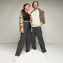 Front view of male and female models in unisex wide-leg joggers with monochrome dahlia pattern — Victoria Island Monochrome Charm