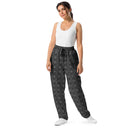 Front view of female model in unisex wide-leg joggers with monochrome dahlia pattern — Victoria Island Monochrome Charmv
