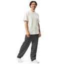 Right front view of male model in unisex wide-leg joggers with monochrome dahlia pattern — Victoria Island Monochrome Charm