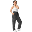Right ftont view of female model in unisex wide-leg joggers with monochrome dahlia pattern — Victoria Island Monochrome Charm