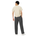 Back view of male model in unisex wide-leg lightweight pants with monochrome dahlia pattern — Victoria Island Monochrome Charm