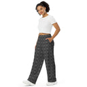 Left front view of female model in unisex wide-leg lightweight pants with monochrome dahlia pattern — Victoria Island Monochrome Charm