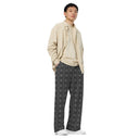 Right front view of male model in unisex wide-leg lightweight pants with monochrome dahlia pattern — Victoria Island Monochrome Charm