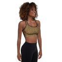 model front angle Padded women’s Vaulted Glory sports bra with a warm gold geometric pattern inspired by Gothic fan-vault architecture in London