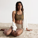 model front Padded women’s Vaulted Glory sports bra with a warm gold geometric pattern inspired by Gothic fan-vault architecture in London