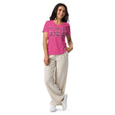 model wearing berry Women’s We Need Jesus Sunrise V-neck tee with lettering filled with an Aruba sunrise photograph