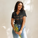 model wearing dark grey heather Women’s We Need Jesus Sunset V-neck tee with lettering filled with a Mount Dora Florida sunset photograph