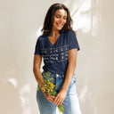 model wearing heather navy Women’s We Need Jesus Sunrise V-neck tee with lettering filled with an Aruba sunrise photograph