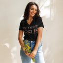 model wearing black Women’s We Need Jesus Sunset V-neck tee with lettering filled with a Mount Dora Florida sunset photograph