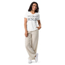 model wearing white Women’s We Need Jesus Sunrise V-neck tee with lettering filled with an Aruba sunrise photograph
